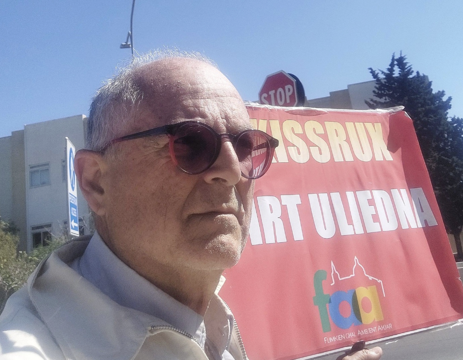 Arnold Cassola holding up a poster reading 'Don't destroy our children's land' (Photo: Arnold Cassola)
